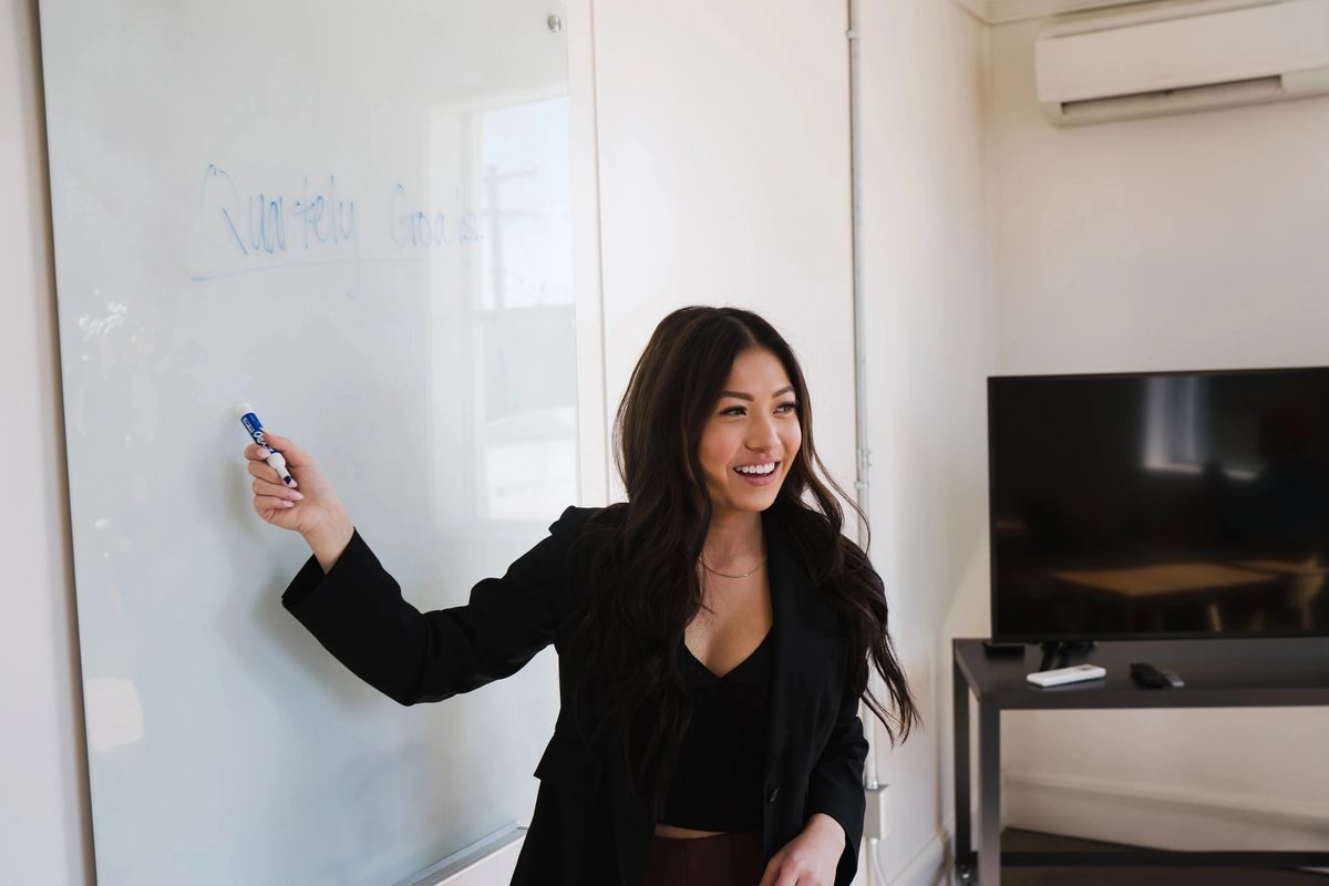 Woman presenting at a whiteboard